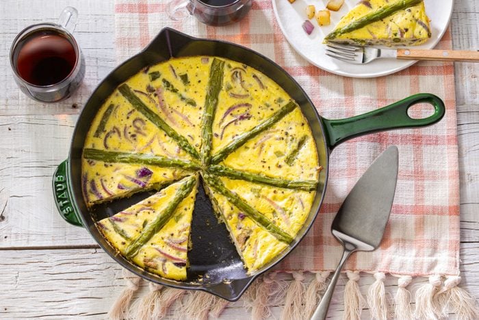 Asparagus Mushroom Frittata in a Pan on a Piece of Cloth on Wooden Surface