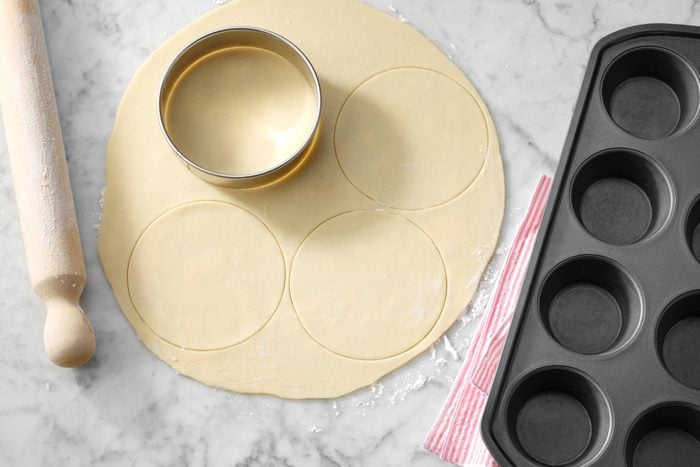 A Cookie Cutter and Dough on a Counter