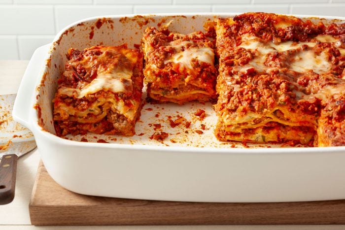 Best Lasagna in a baking dish on a wooden tray