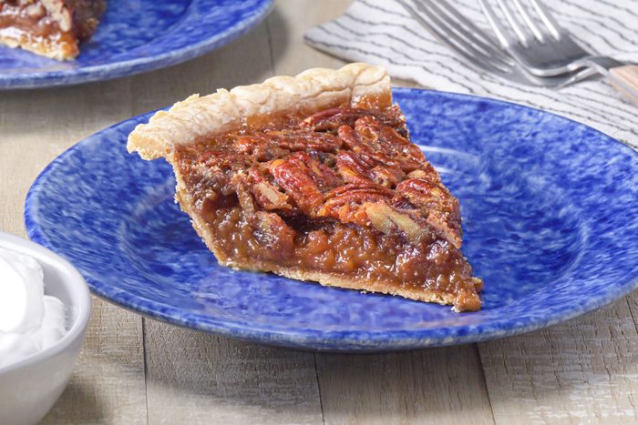 A slice of Bourbon Pecan Pie served in a plate