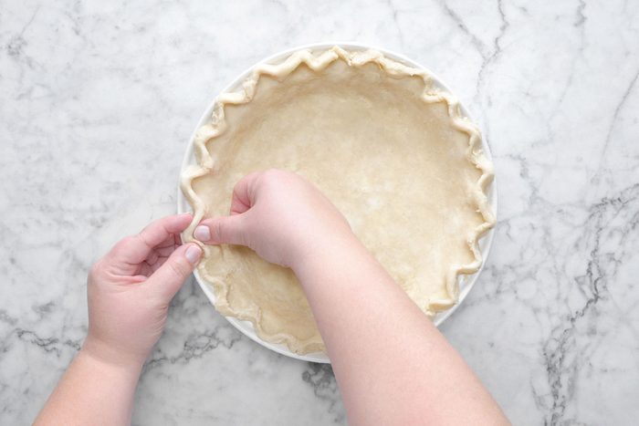 A person Shaping the dough into a flat disk