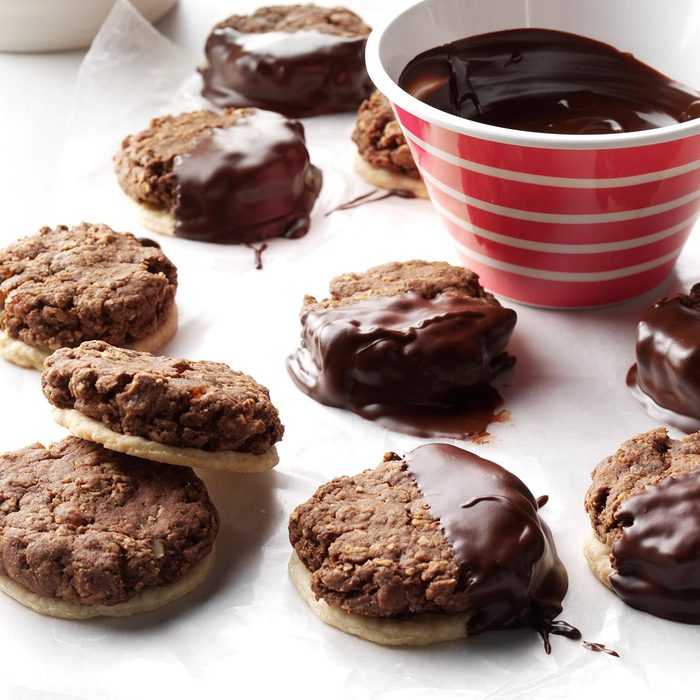 Chocolate Lebkuchen cookies on a white parchment paper with german chocolate dipping sauce