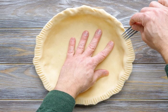 Setting the Dough in the Pie Plate and Flattening the Edges with a Fork