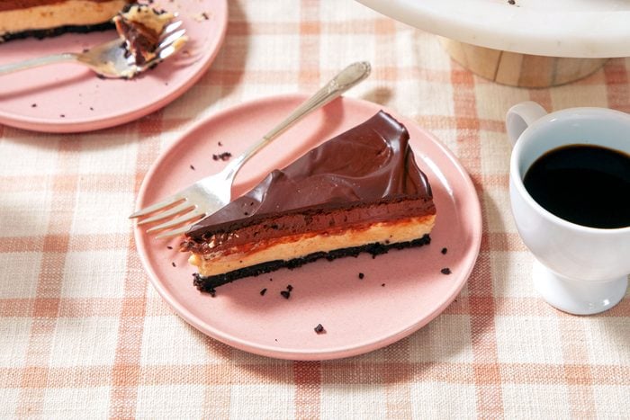A Slice of Chocolate & Peanut Butter Mousse Cheesecake Served in a Small Plate with Fork