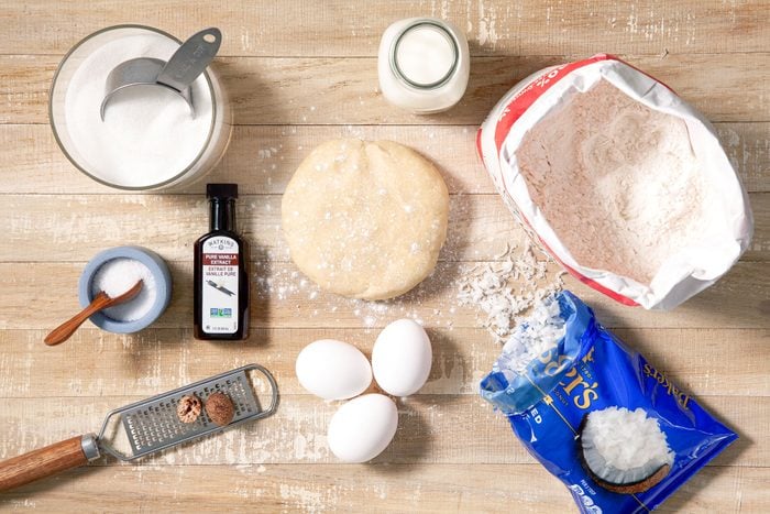 All Ingredients for Coconut Custard Pie on Wooden Surface