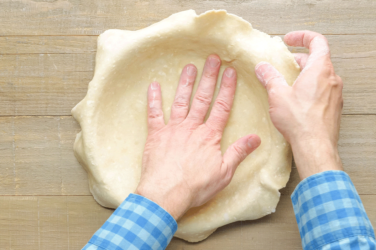 Pressing Coconut Custard Pie Dough in Pie Plate with Hands