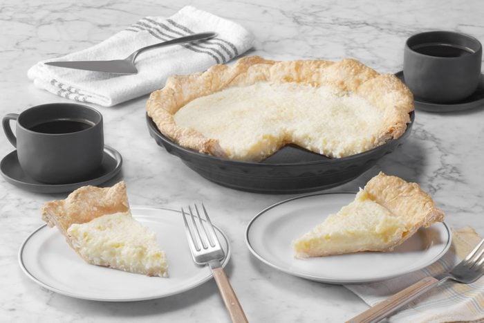A coconut pie on plates with a fork and knife