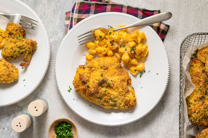 Cornmeal Fried Chicken Served in Ceramic Plate with Fork on Marble Surface