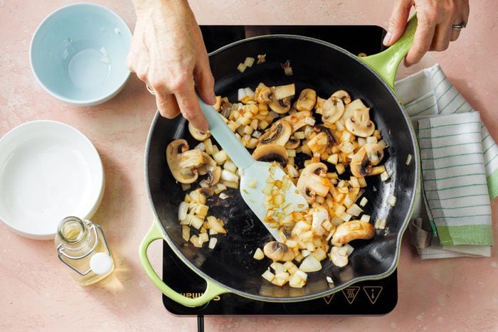 Sautéing Onions and Mushrooms in a Large Skillet on Induction Cooktop