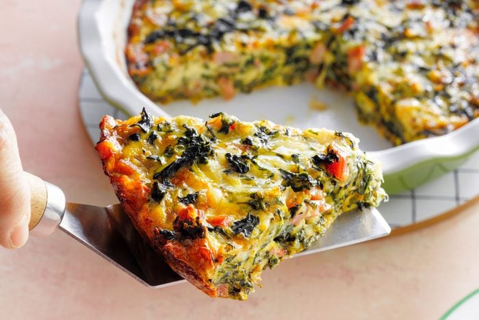 A Slice of Crustless Spinach Quiche on a Pizza Server