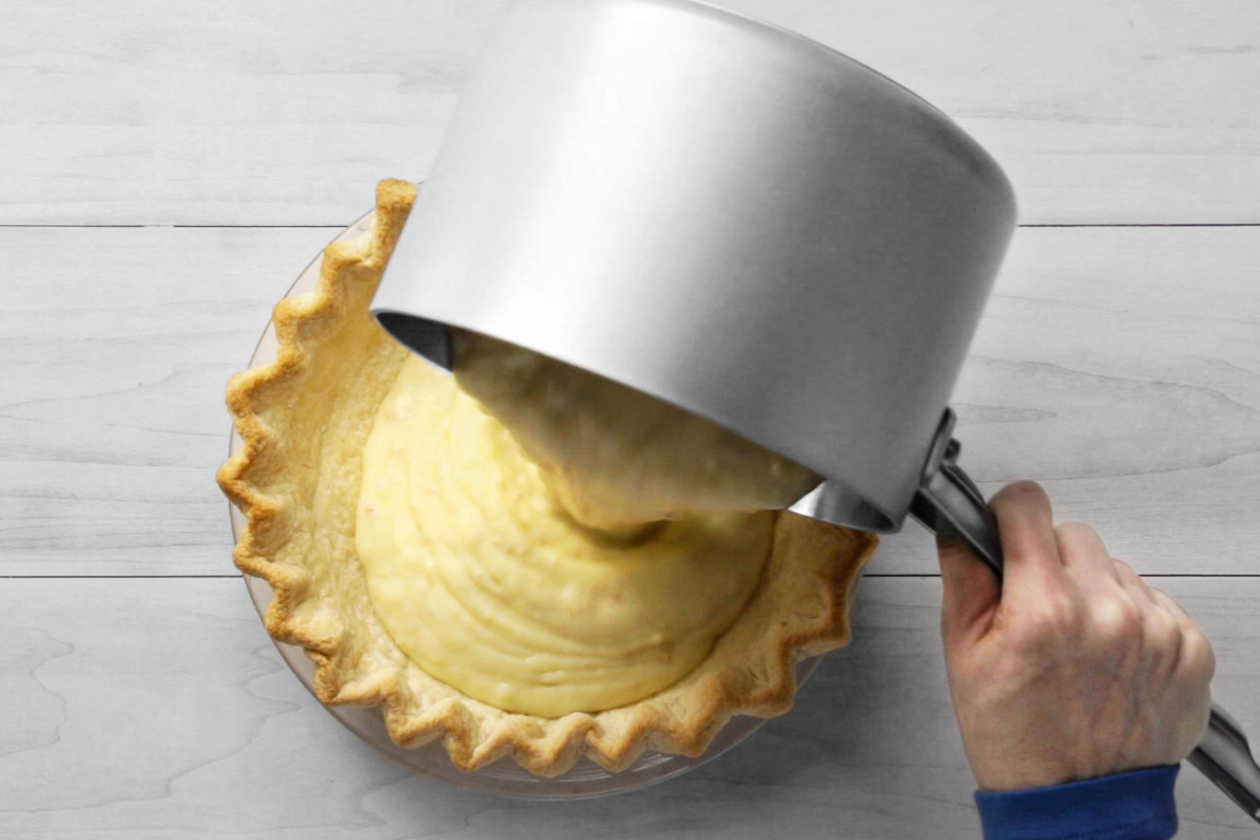 Pouring the pudding filling into your prepared pie crust