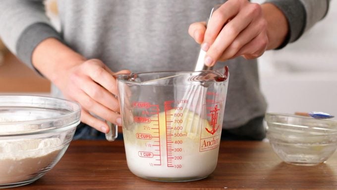 Person whisking wet ingredients together