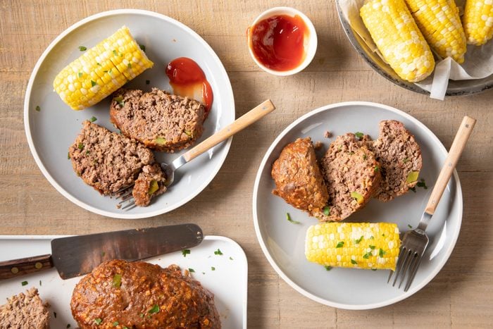 Grilled Meat Loaf served in plate with corn and sauce