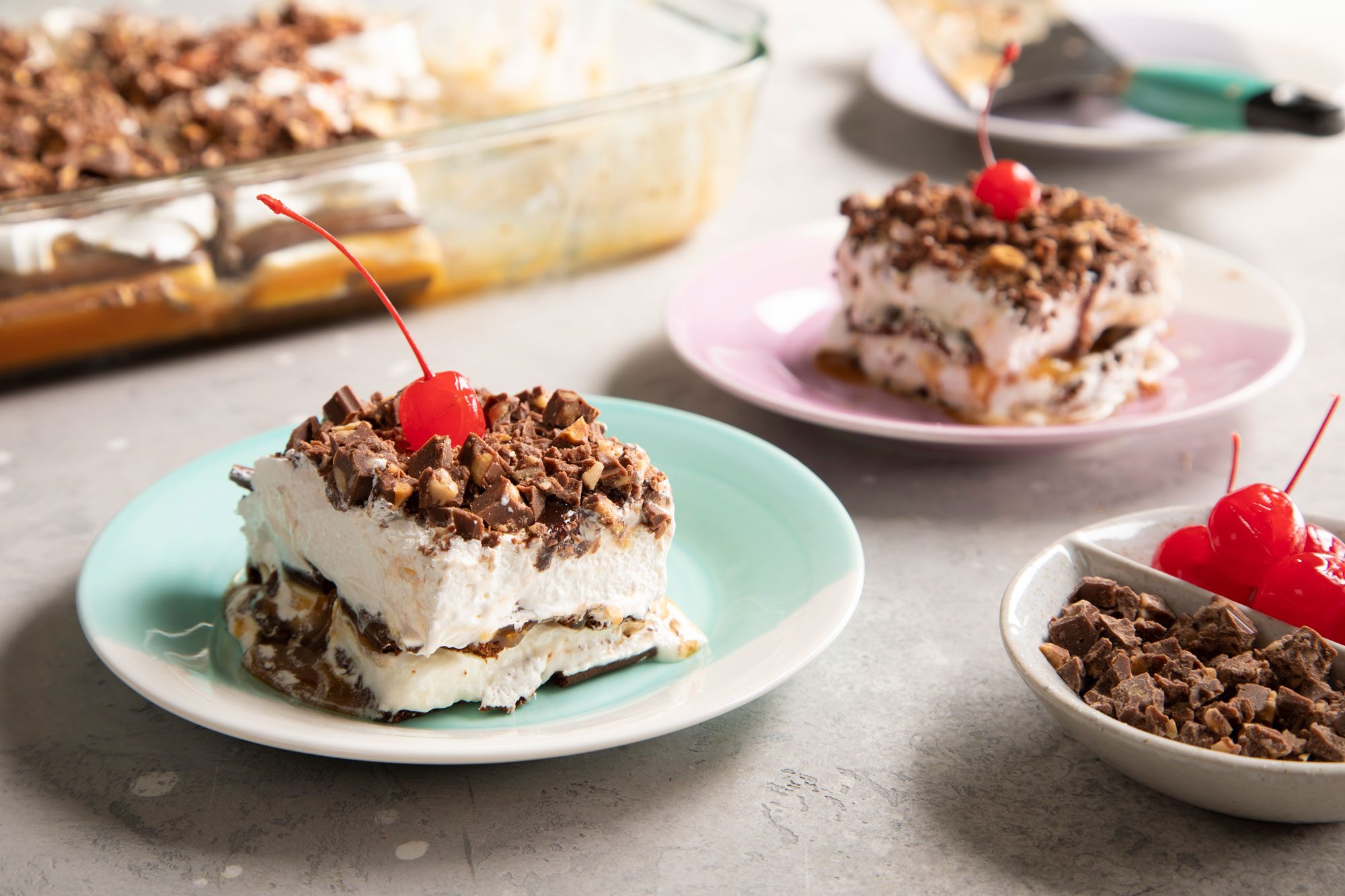 Ice Cream Sandwich cake with a cherry on top, served on plates