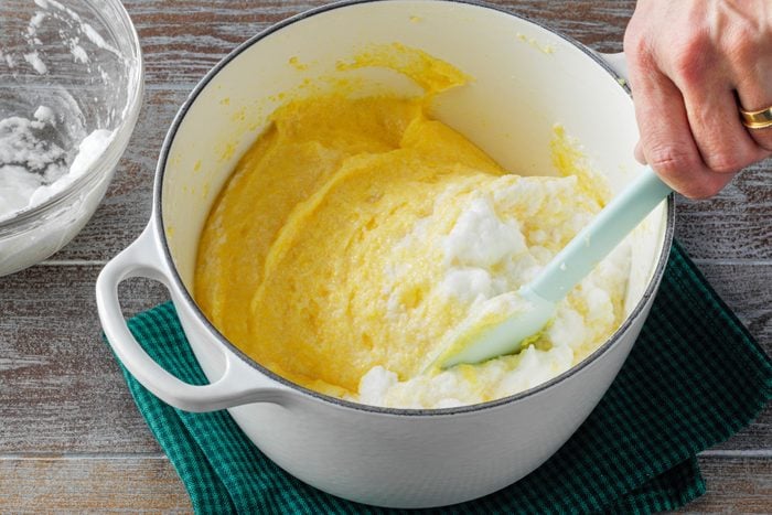Mixing egg whites in Cornmeal mixture in a large pan