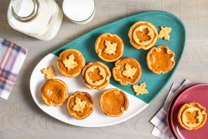Mini Pumpkin Pies in a Two Tone Green White Plate on Wooden Surface