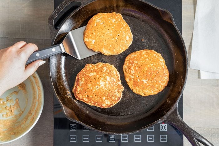 Cooking Oatmeal Pancakes on a Cast Iron Skillet on Induction Cooktop