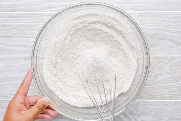 Mixing Ingredients in a Large Glass Bowl to Make Batter for Pumpkin Bread