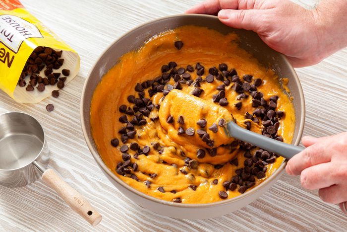 In A Large Bowl Mixing Chocolate Chips with Pumpkin Chocolate Chip Muffins Mixture