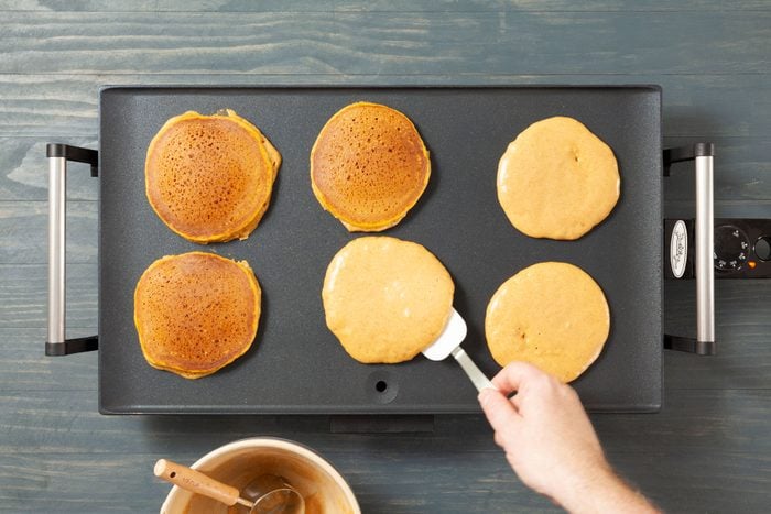 A Pumpkin Pancake Cooking on a Pan