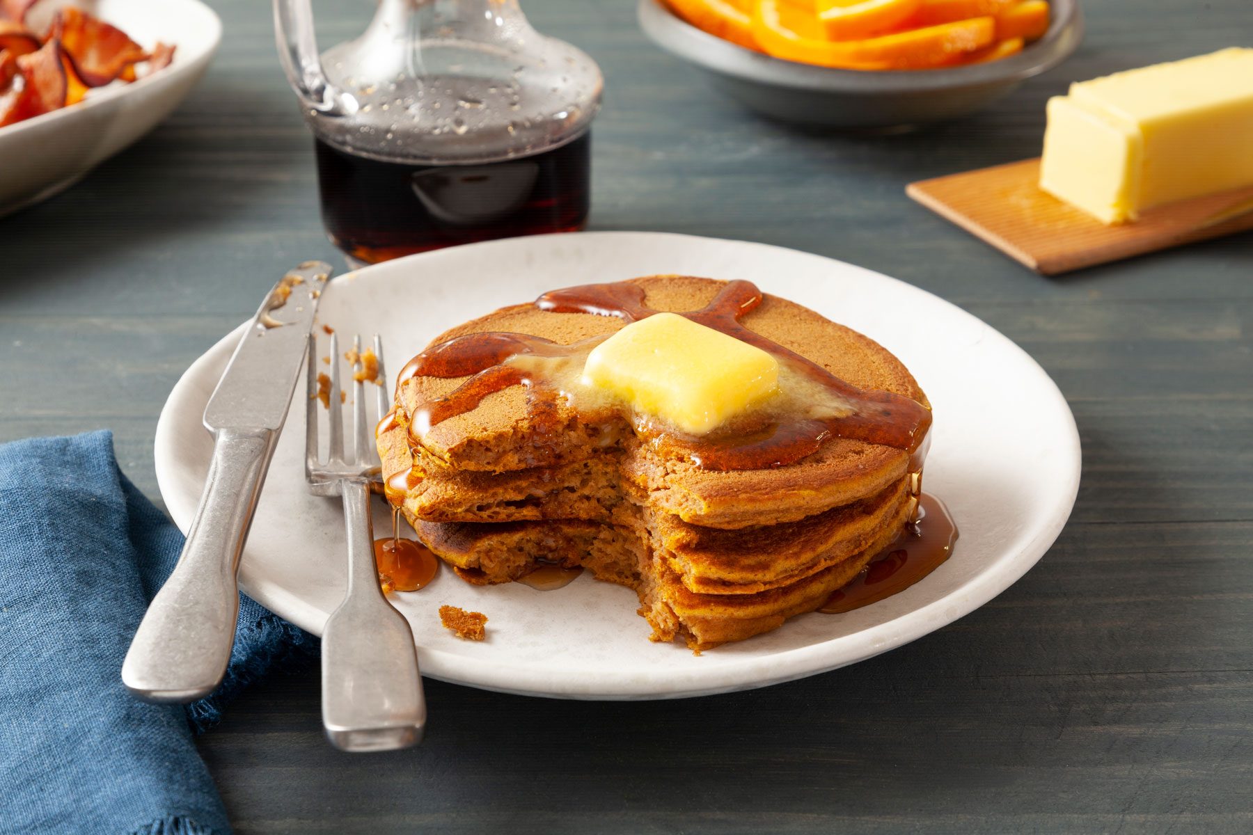 A Plate of Pumpkin Pancakes With Butter and Syrup on It