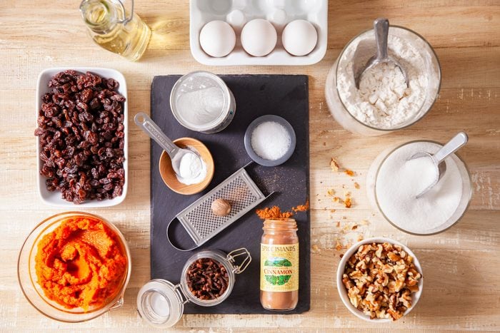 All Ingredients for Pumpkin Streusel Muffins on wooden surface and Stone Plate