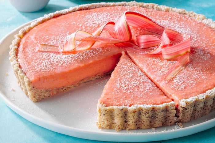 Rhubarb Tart With Shortbread Crust in a White Plate on Greenish Blue Background