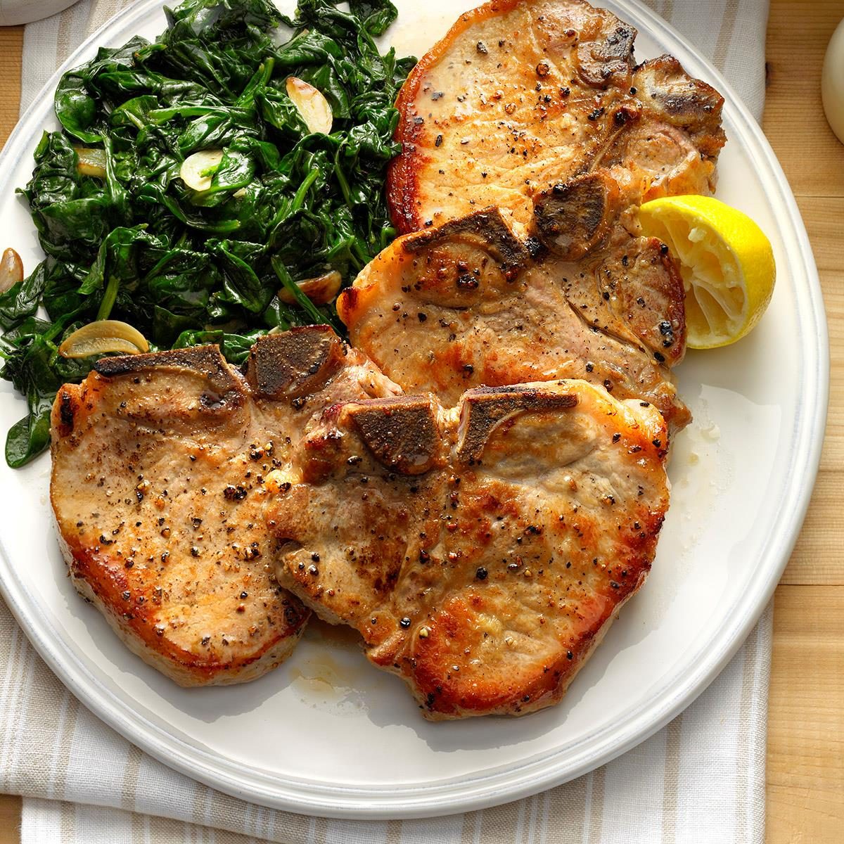 Sauteed Pork Chops with Garlic Spinach Recipe | Taste of Home