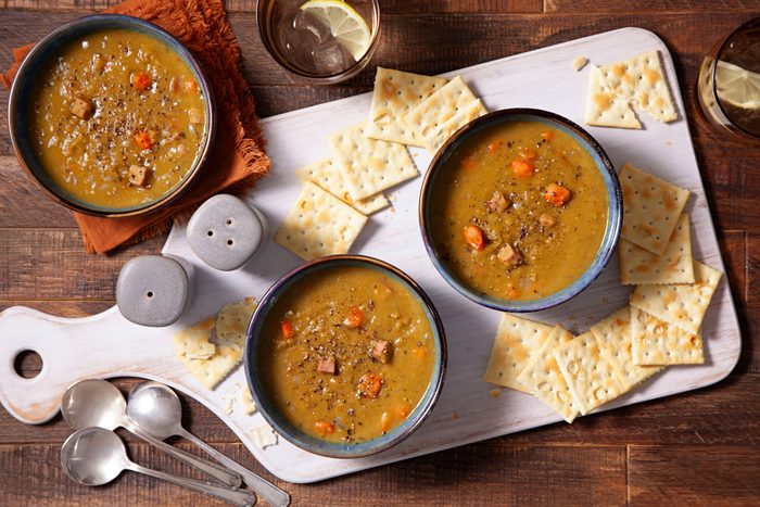 Slow Cooker Split Pea Soup served in bowls on a cutting board