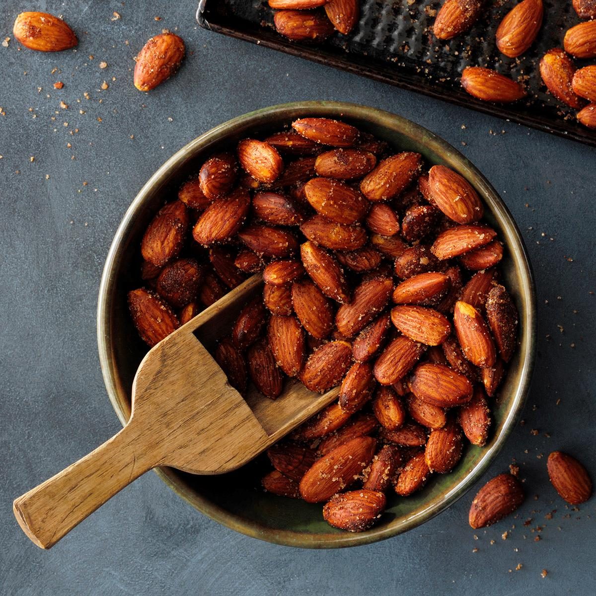 spicy almonds in a bowl with scoop