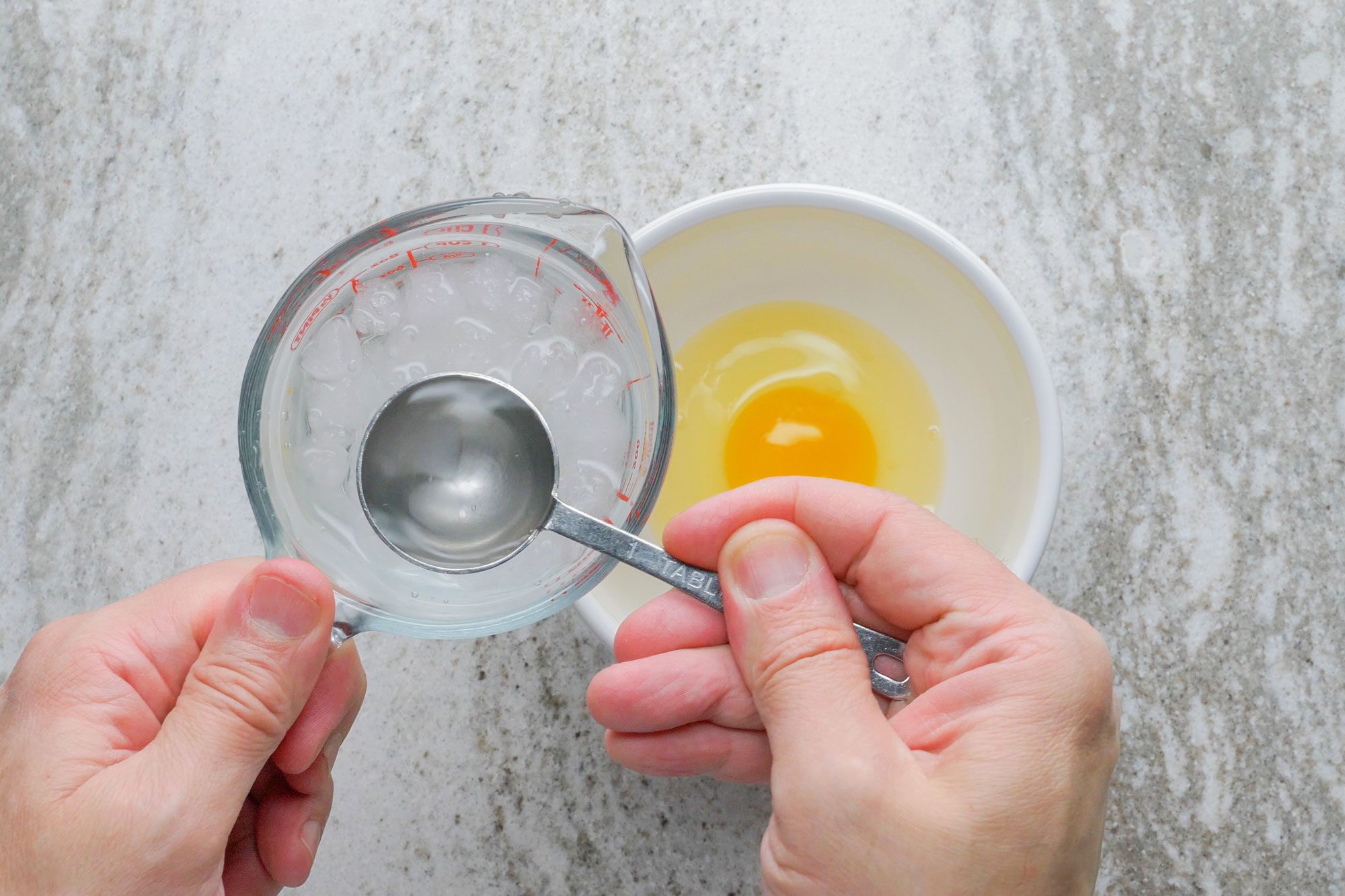 In a small bowl mix egg, ice water and vinegar