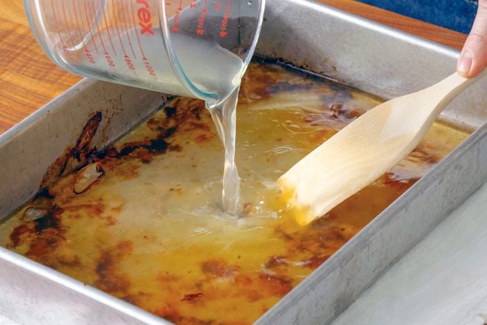 Chicken Broth is Being Poured Into a Pan