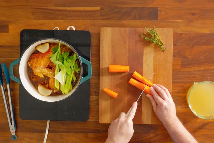 A Person Cutting Vegetables on a Cutting Board