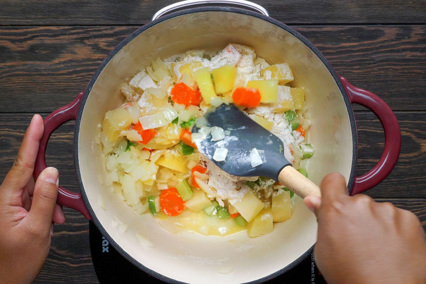 Vegetables and flour are whisk in a pot to make Turkey Potpies 