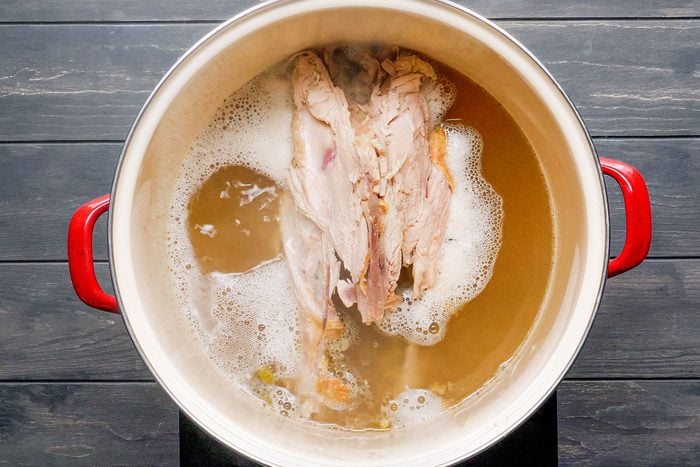 turkey carcass in hot boiling water in stockpot