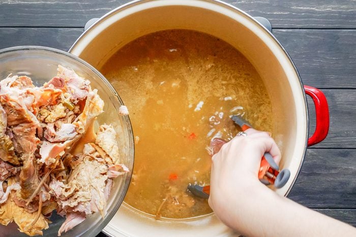 removing turkey carcass from stockpot