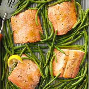 salmon and green beans on a baking sheet
