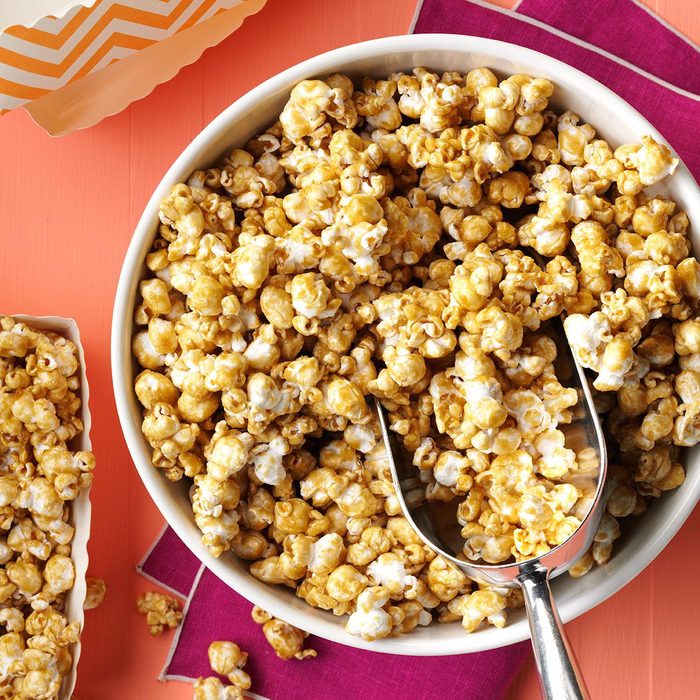 caramel corn in bowl with a scoop