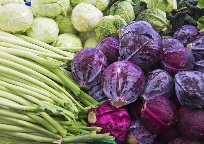 green and purple cabbage, leek on market for sale