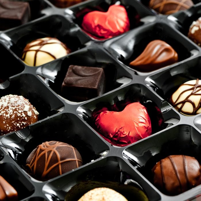 chocolates in a box, with red love heart shaped chocolate; Shutterstock ID 123648574