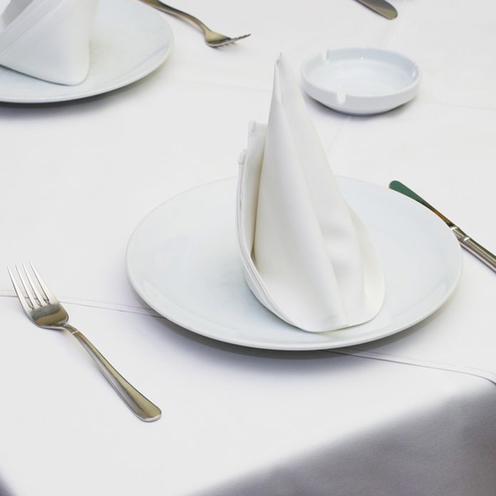 Empty served restaurant table with white tablecloth; Shutterstock ID 2382298
