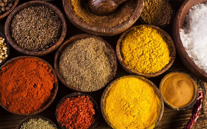 Spices and herbs in wooden bowls