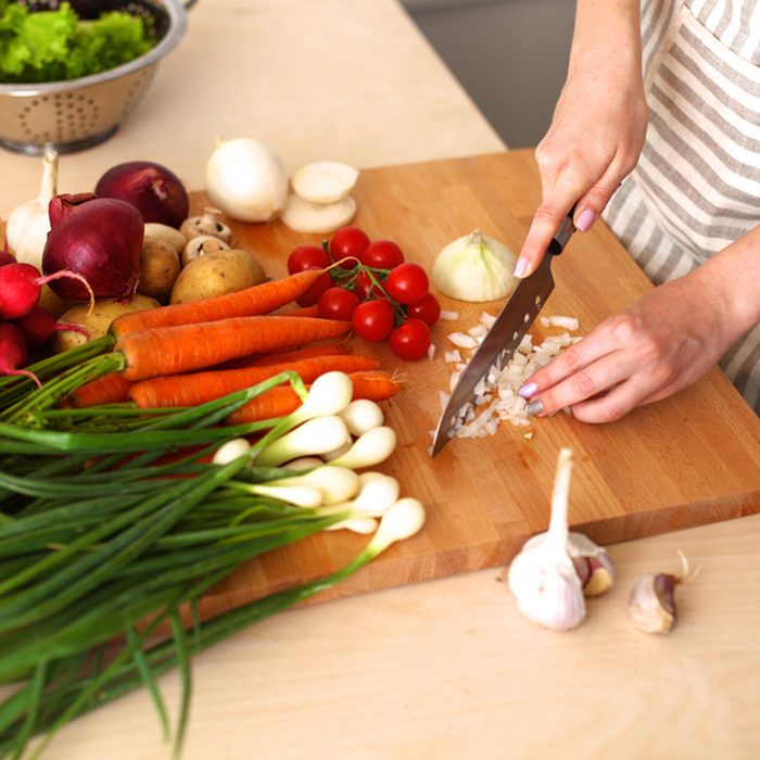 Cook's hands preparing vegetable salad - closeup shot; Shutterstock ID 301882538; Job (TFH, TOH, RD, BNB, CWM, CM): Taste of Home