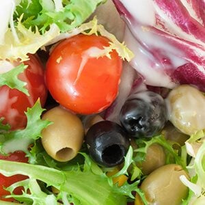 macro background of fresh mediterranean salad with dressing yogurt
