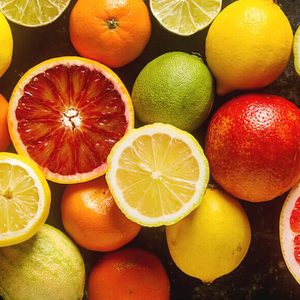 Citrus juice fruit and slices of orange, grapefruit, lemon, lime. Vitamin C. Black background