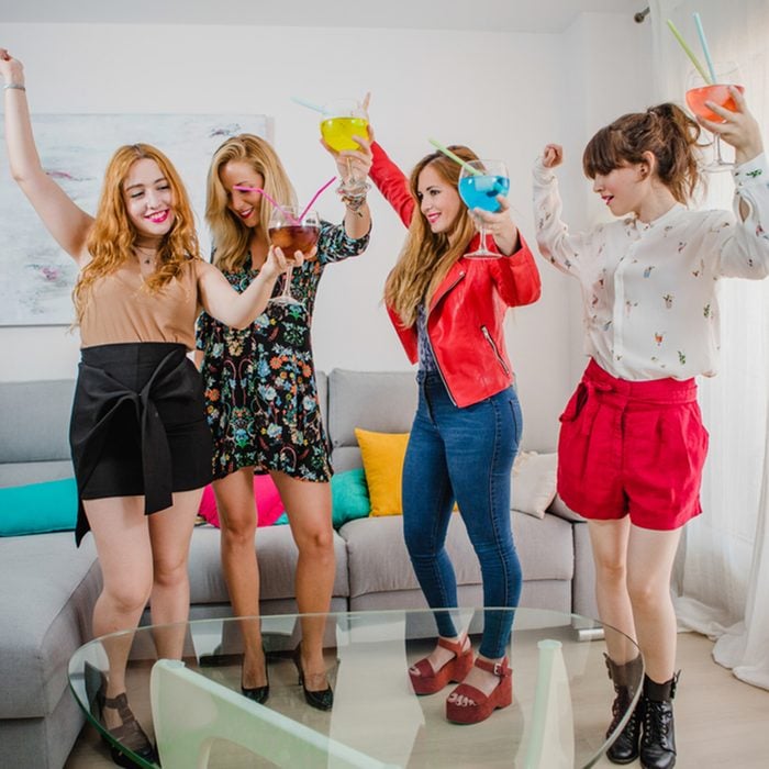 friendship, people and pajama party concept - happy friends or teenage girls having fun, dancing and jumping at home; Shutterstock ID 752420494