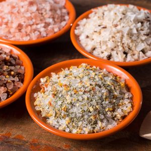 Variety of sea salt, pink Himalayan salt, colorful salt with dried chili pepper, herbs and spices