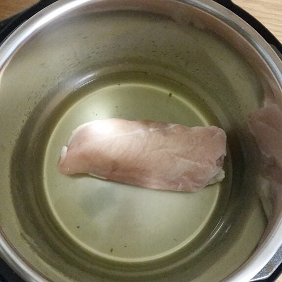 Piece of chicken at the bottom of an instant pot