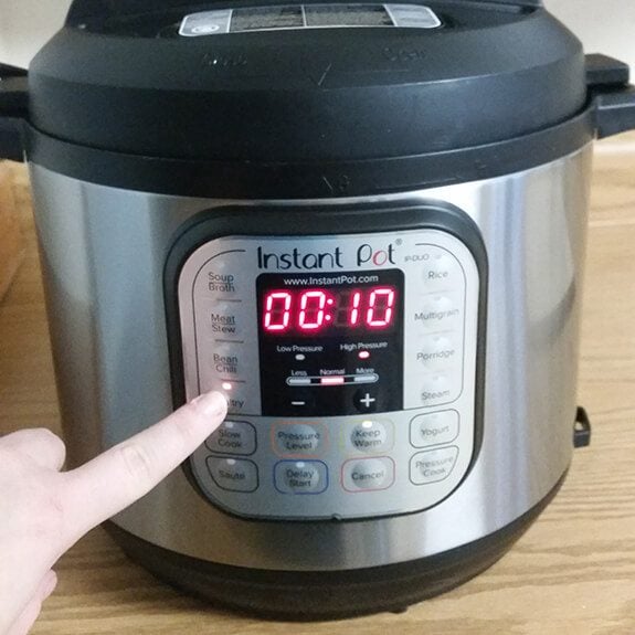 Person changing the settings of their instant pot