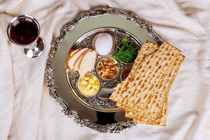 A Passover Seder plate, glass of wine and matzo for a Passover seder.